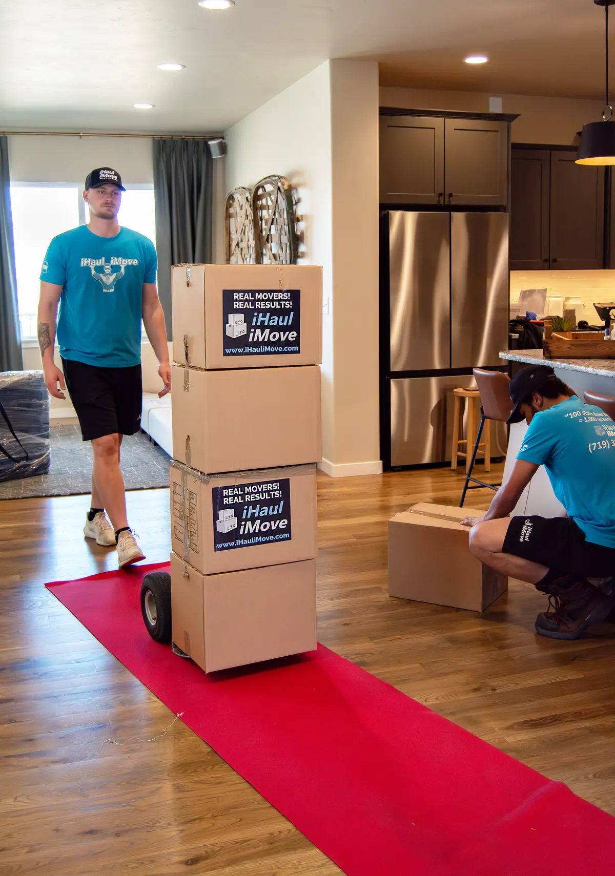 Moving crew transporting boxes with dolly